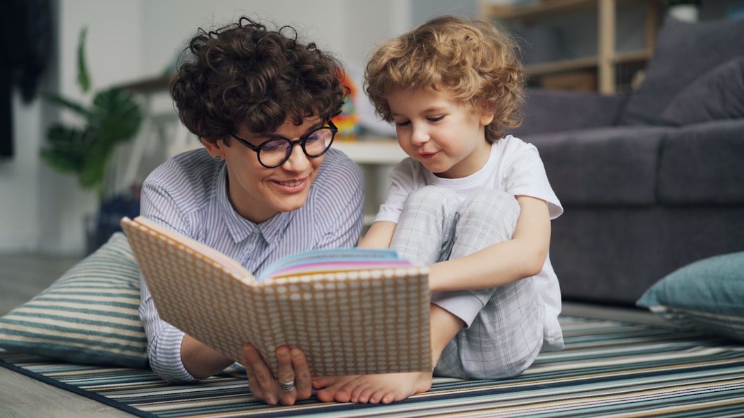 a man reading a book to a little girl