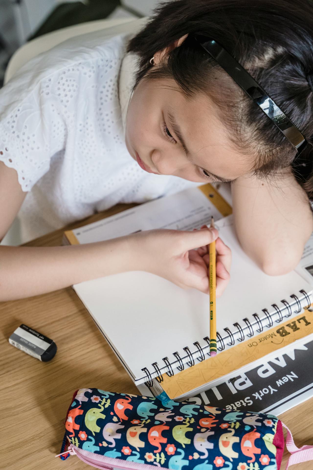Worried child looking at math homework while parent realizes their role in creating anxiety